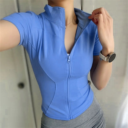 Periwinkle blue fitted polyester sports jacket with zip front for yoga and running.