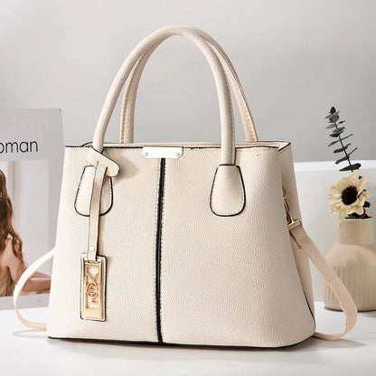 Off-white textured faux leather structured tote bag with zip closure and adjustable strap for everyday use.