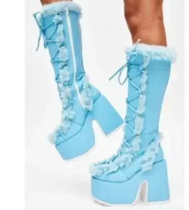 Light blue faux fur platform mid-calf wedge boots with lace-up fronts and fluffy trim.
