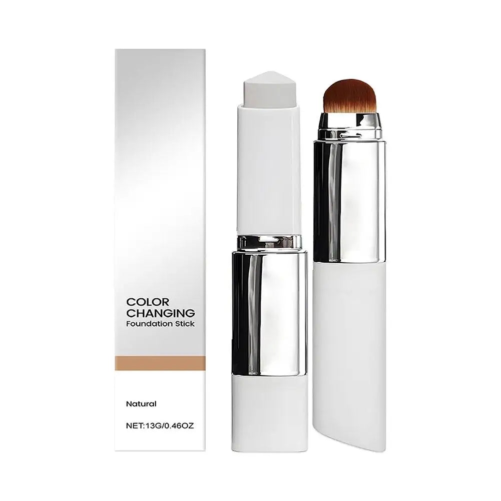 Foundation stick with built-in makeup brush and color-changing formula in white and silver packaging
