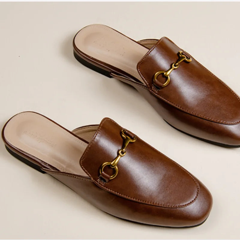 Brown closed-toe slip-on shoes featuring a gold metal chain detail for everyday outdoor wear.