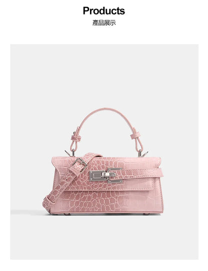 Pink faux leather crossbody bag with croc texture, silver clasp, and adjustable strap for daily errands.