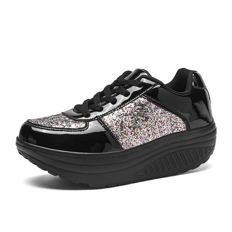 Black lace-up platform sneaker with shiny patent panels and colorful sequin-covered side and toe sections.
