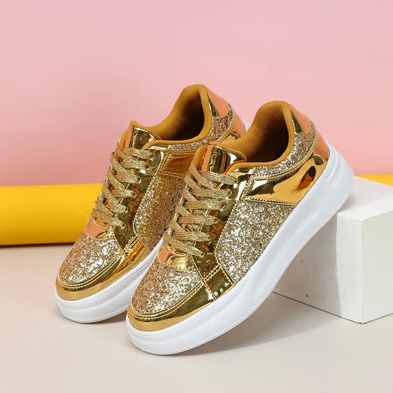 Gold sequin and metallic lace-up casual sneakers with thick white soles.