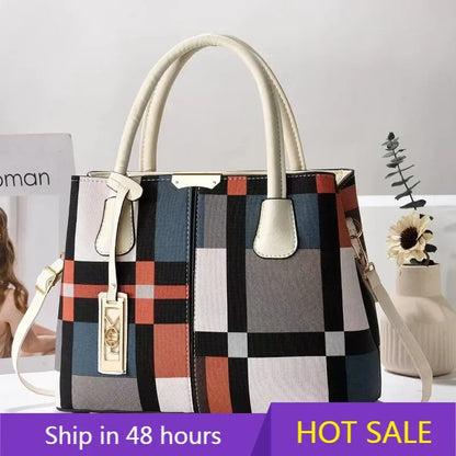 Multicolor plaid structured tote bag with zip closure and adjustable strap for everyday use.