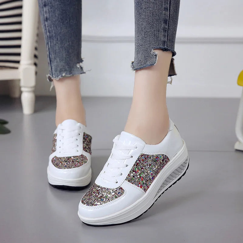 White lace-up platform sneakers with multi-colored sequined panels and thick soles.