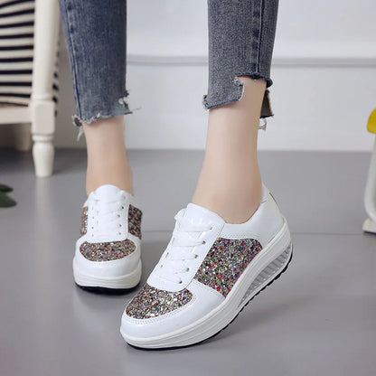 White lace-up platform sneakers with multi-colored sequined panels and thick soles.