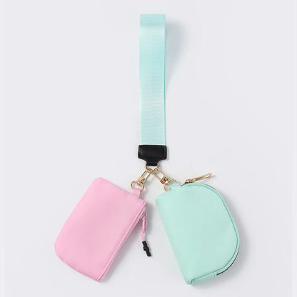 Pink and mint nylon zip closure wristlet wallet with dual pouches for daily errands.