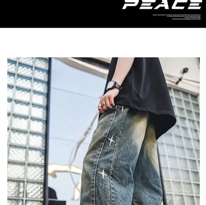 Blue acid-wash denim jeans featuring a loose fit and white star embroidery, worn as casual streetwear.