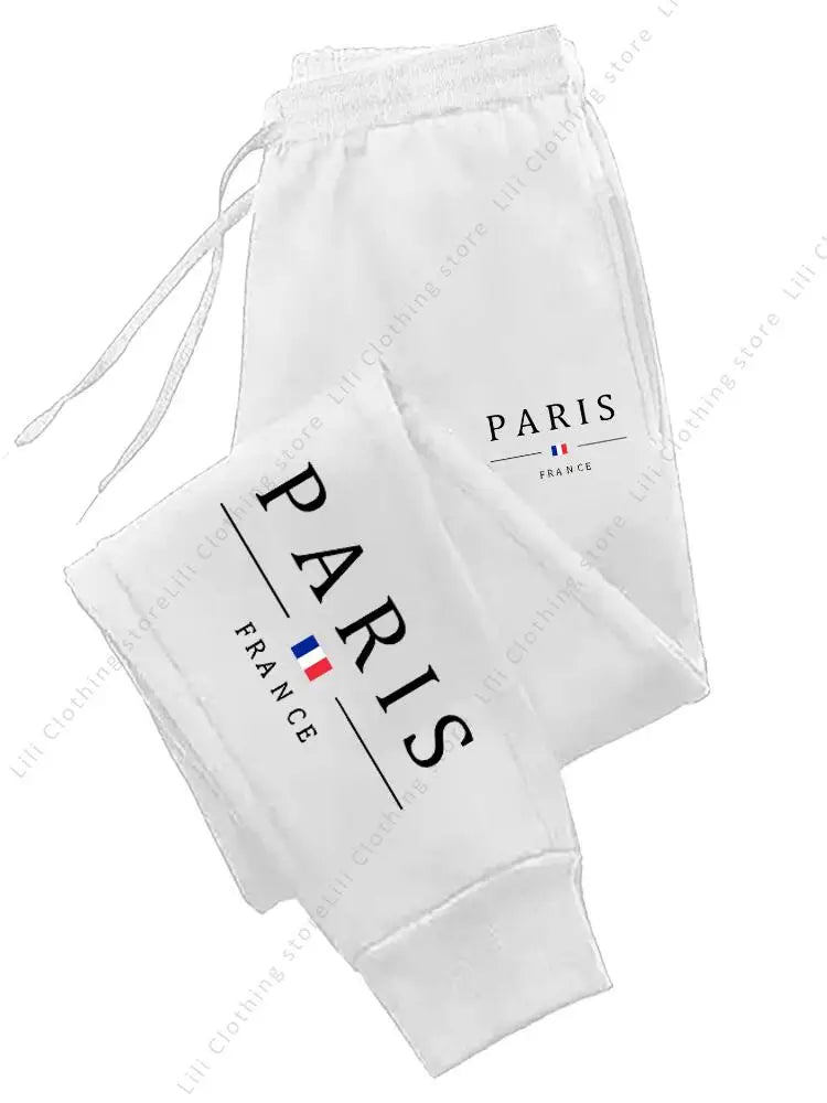White fleece-lined stretchy joggers with Paris graphic for lounge wear.
