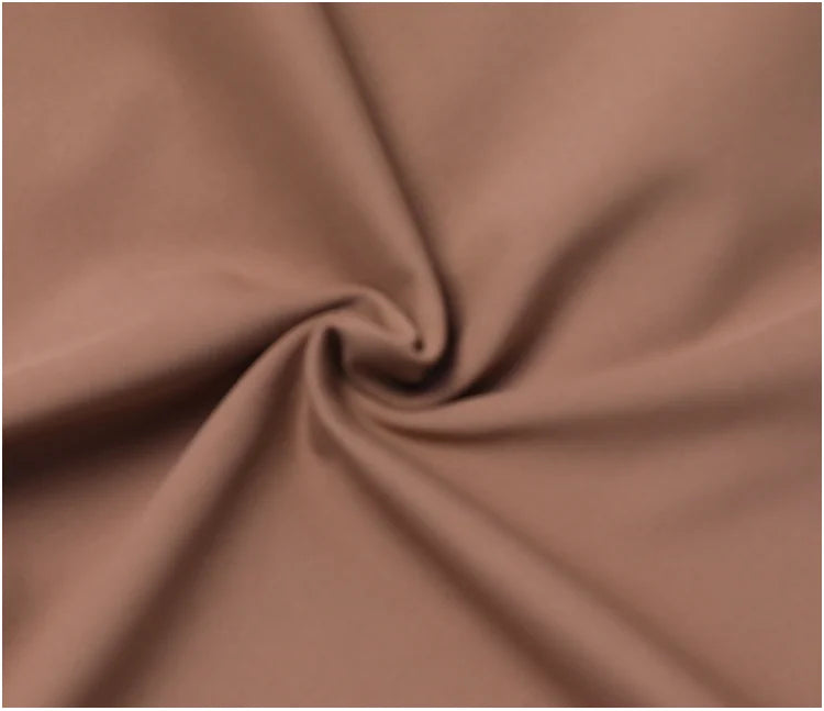 Swirled matte mocha polyester fabric of a stretchy women's sport jacket for gym training.