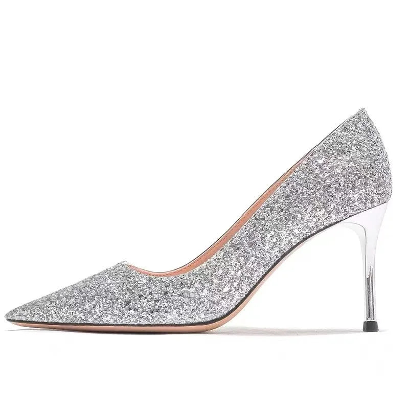 Silver glitter pointed-toe dress shoes with a slim metallic heel for weddings.