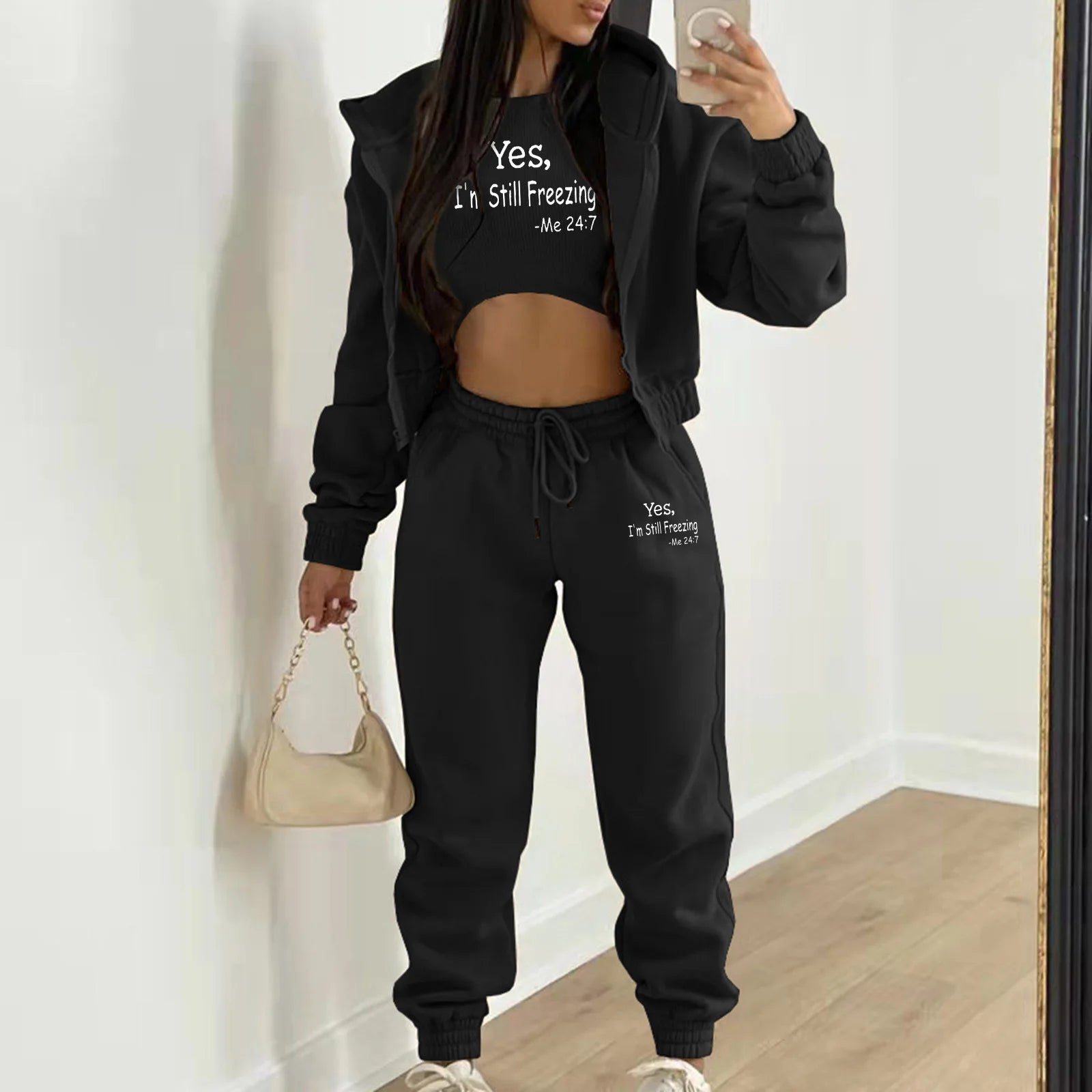 Black knit sweater set with white letter print, hooded crop top, and relaxed drawstring joggers for lounging.