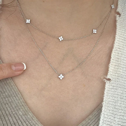 Women's gold-tone layered chain necklace with pendant detail