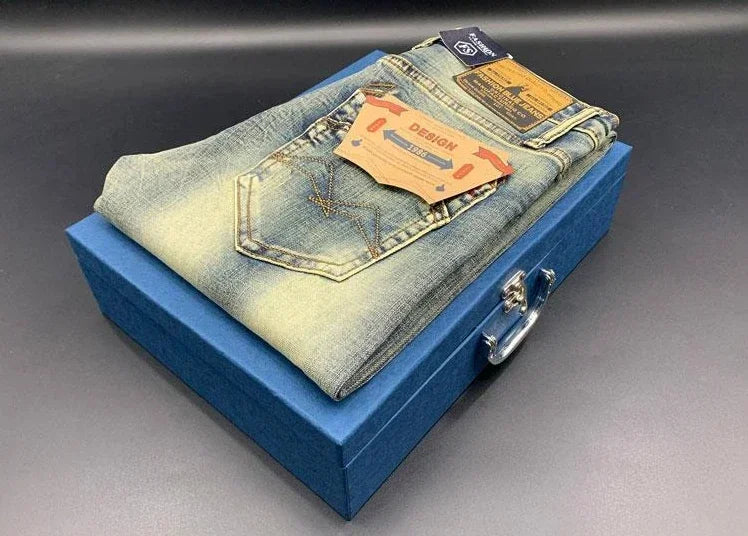 Light wash denim folded on a blue box, these stretchy tapered jeans are styled with back pockets for daily comfort.