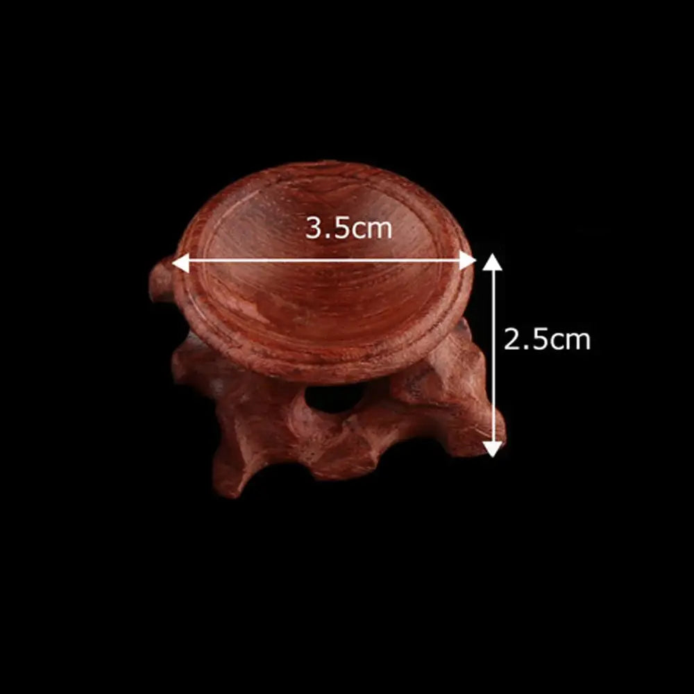 Red-brown wood crystal ball stand with a 3.5cm wide bowl and 2.5cm height.