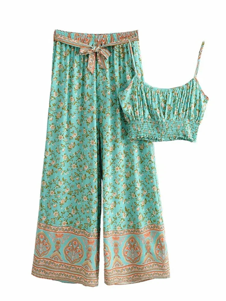 Teal flowy floral two-piece set with wide leg pants and a smocked crop top for summer vacation outfits.