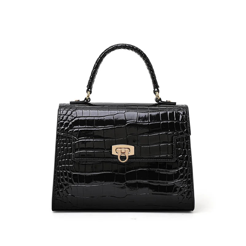 Black glossy crocodile-embossed leather handbag with a top handle, structured flap, and gold-tone clasp closure.
