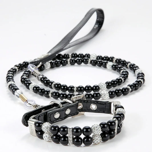 Black beaded pet collar and matching leash with rhinestone accents on a white background.