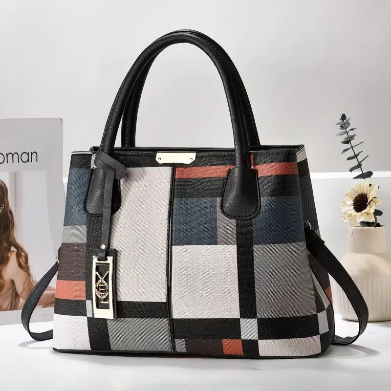 Multi-colored geometric faux leather structured tote bag with zip closure for everyday use.