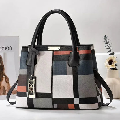 Multi-colored geometric faux leather structured tote bag with zip closure for everyday use.