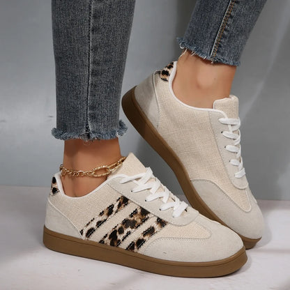 Beige and leopard print canvas slip-on sneakers with a flat brown sole for casual walking.