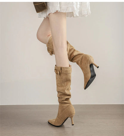 Khaki suede high-heel slouch boots with a pointed toe and buckle strap detail.