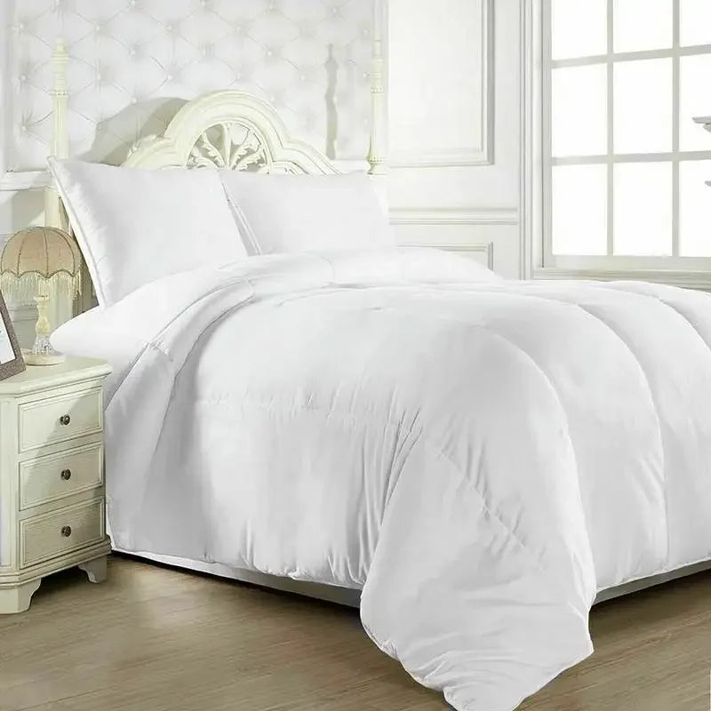 Fluffy white goose down comforter and matching pillows on a made bed.