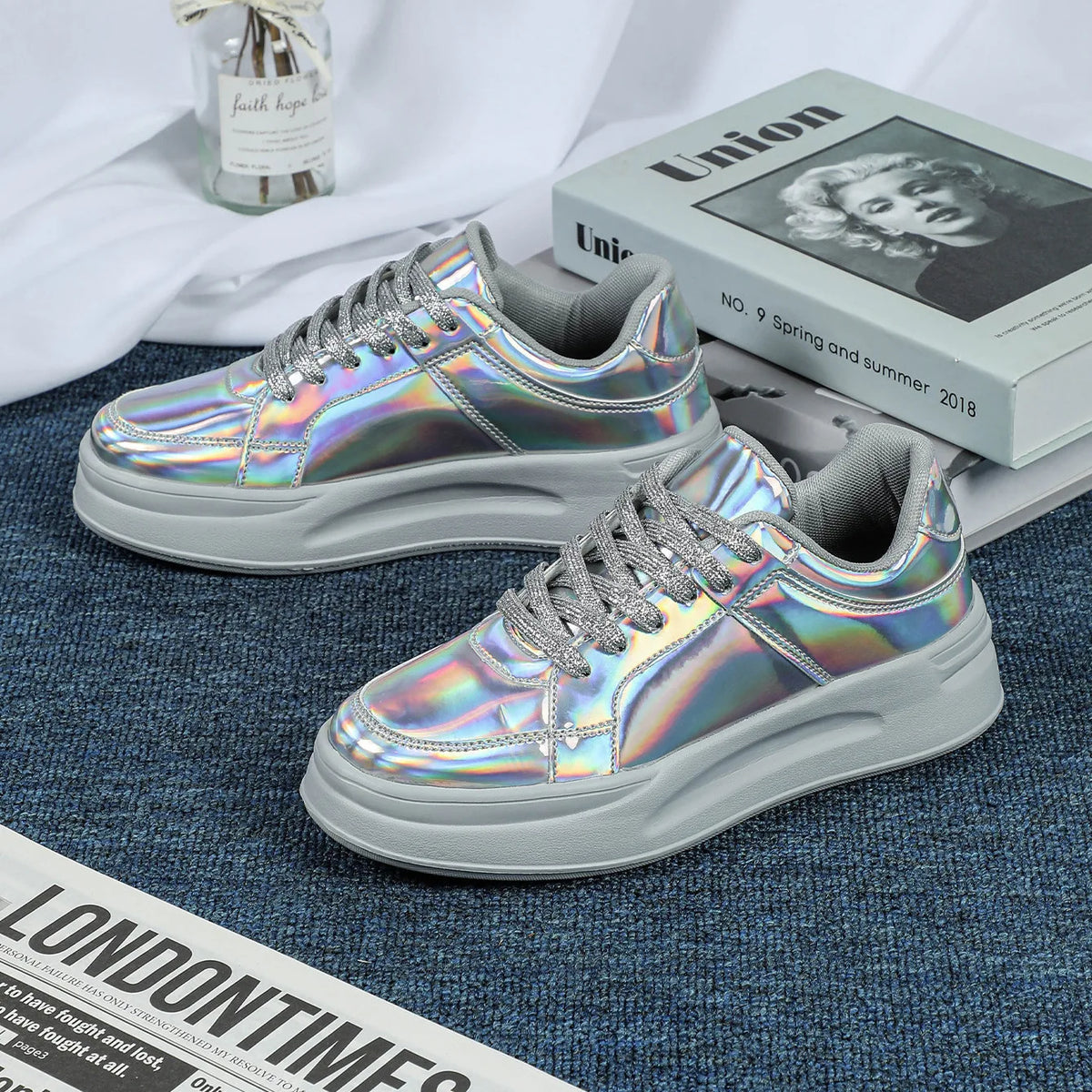 Silver iridescent lace-up casual sneakers with thick soles and glittery laces.