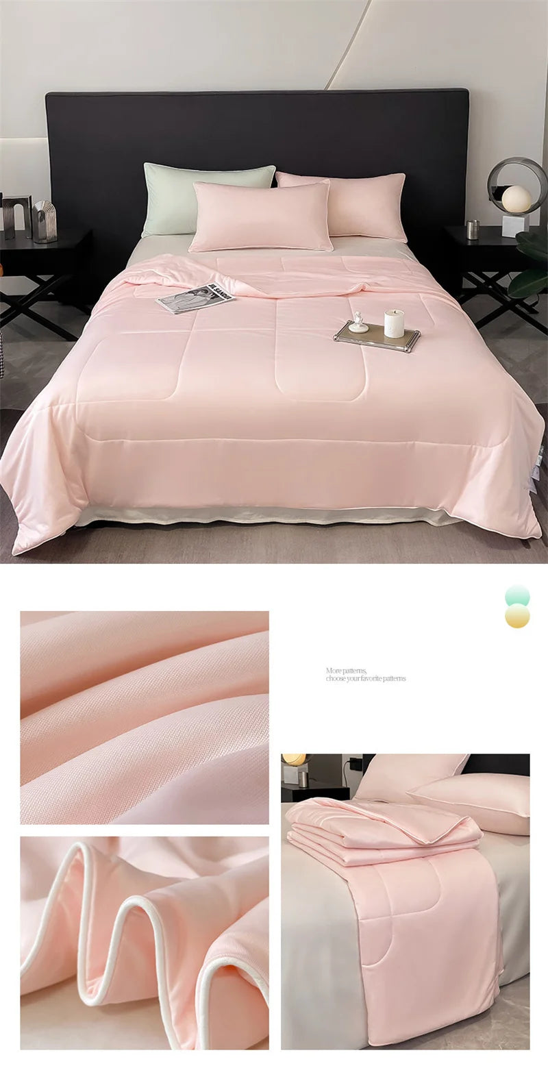 Soft pink cooling comforter with piped edges and breathable fabric for a comfortable night’s sleep.