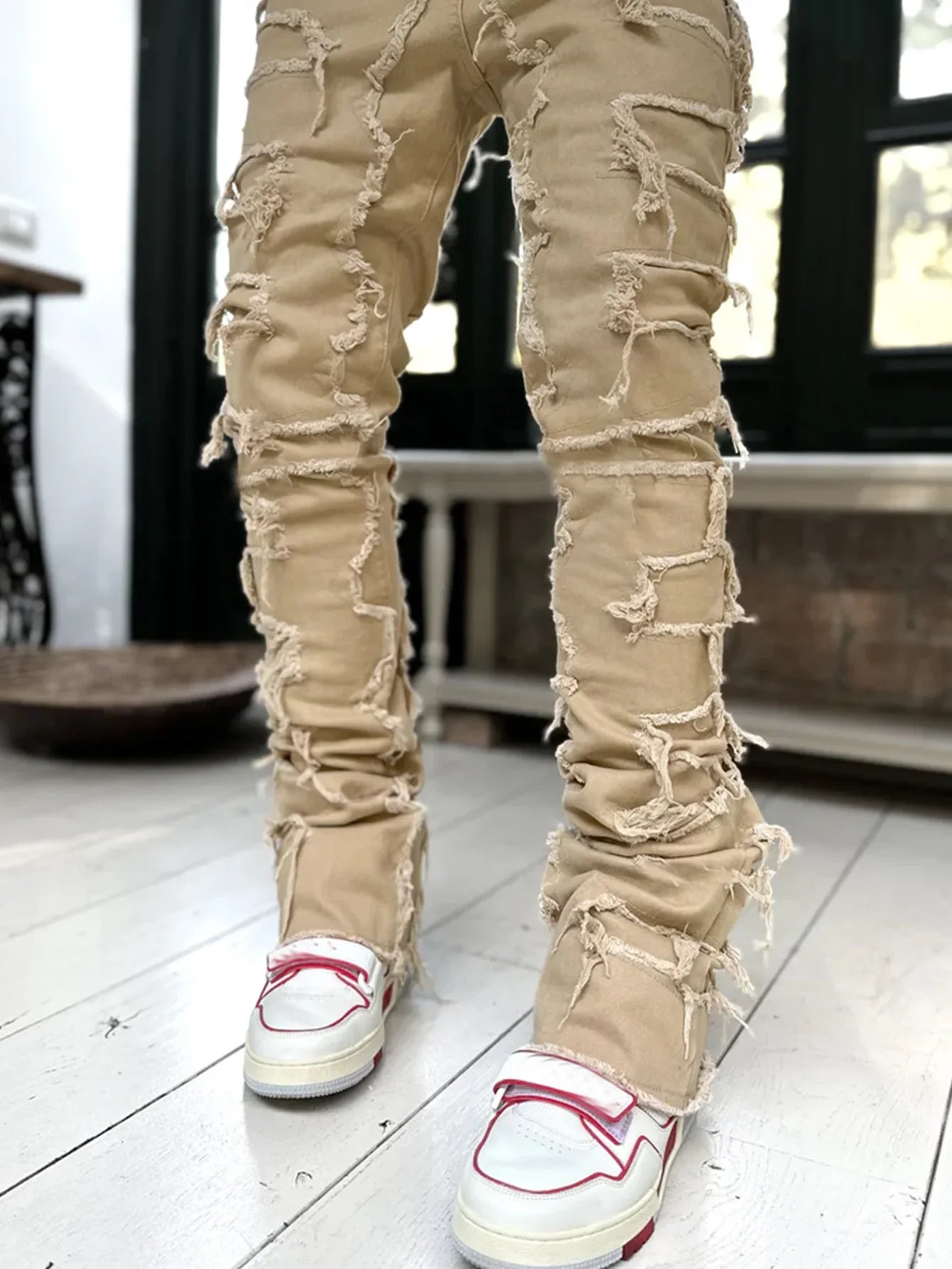 Beige slim straight fit jeans with distressed ripped detailing and a fitted design for street style outfits.