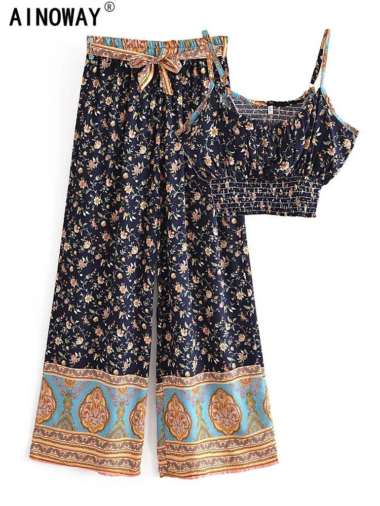 Navy floral flowy two-piece set featuring wide leg pants with a drawstring and a smocked crop top for beach vacations.