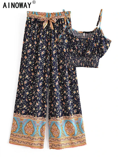 Navy floral flowy two-piece set featuring wide leg pants with a drawstring and a smocked crop top for beach vacations.