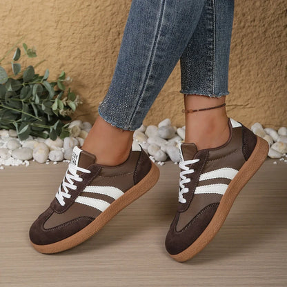 Brown leather and suede sneakers with white stripes and gum soles, slip-on shoes for casual walking.
