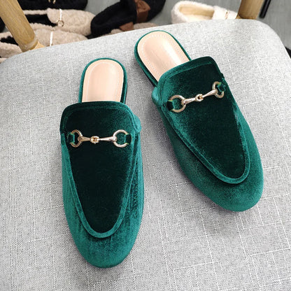 Dark green velvet slip-on shoes with gold chain hardware for all-day wear.