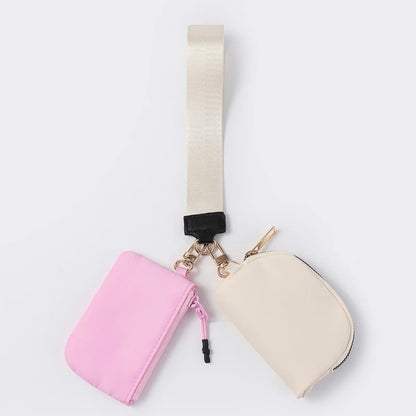 Pink and beige nylon dual pouch with zip closure and adjustable strap, a waterproof wristlet wallet for daily errands.