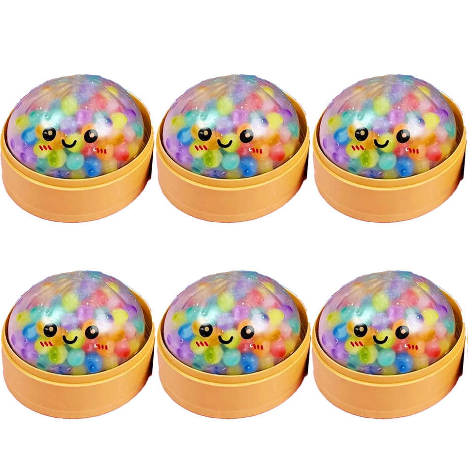 Clear dumpling squishy fidget toy with colorful beads and a smiling face in a yellow steamer for sensory play.
