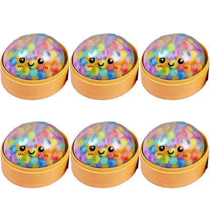 Clear dumpling squishy fidget toy with colorful beads and a smiling face in a yellow steamer for sensory play.