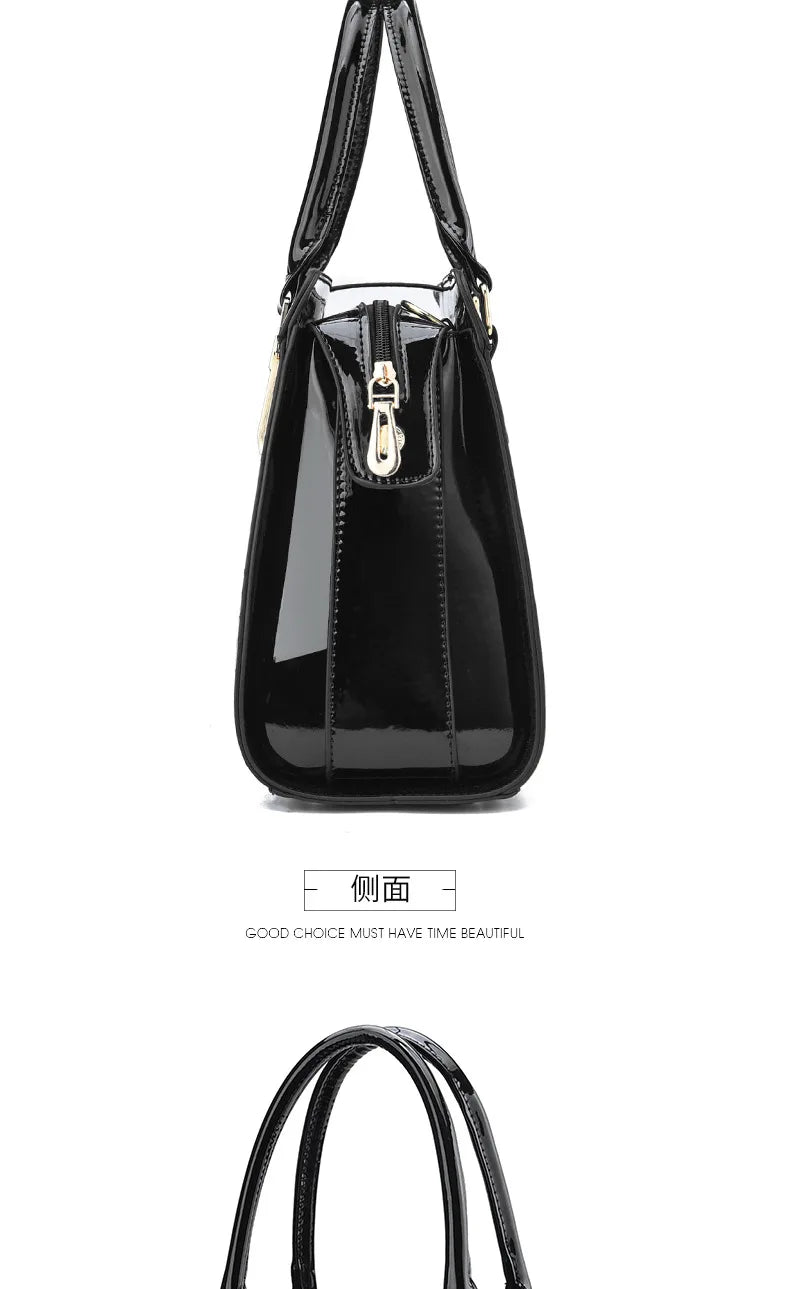 Black patent leather handbag with dual top handles, side zipper, and gold hardware.