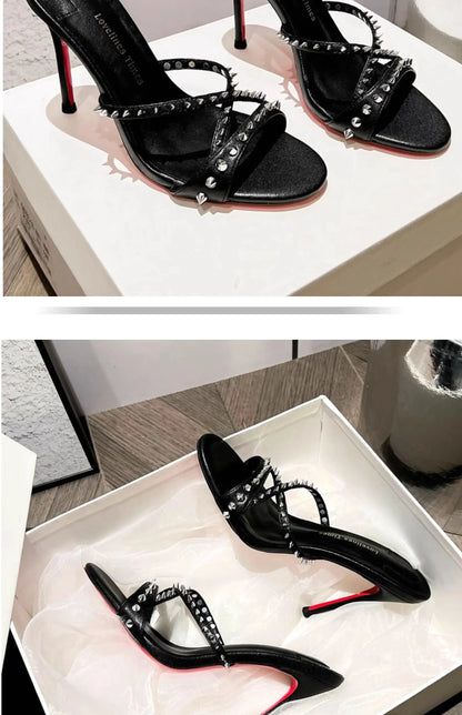 Black strappy open toe sandals with silver rivets and slim heels for formal events.