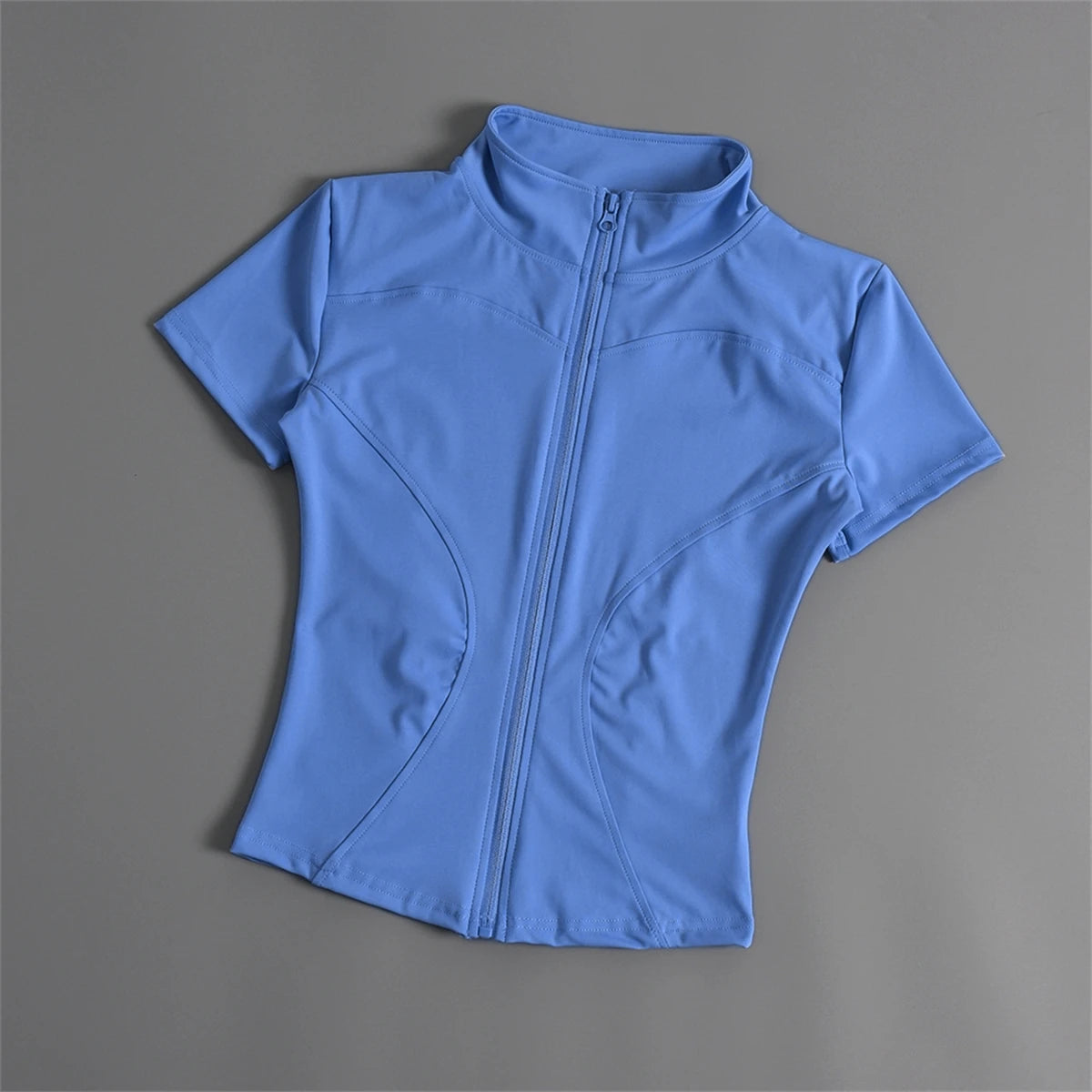 Light blue fitted sports jacket with a front zip, short sleeves, and polyester fabric for running or yoga.