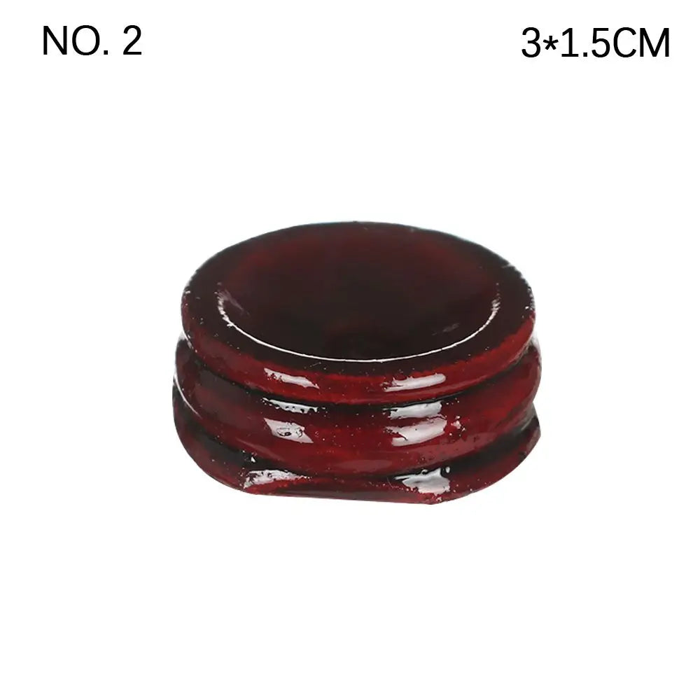 Dark reddish-brown glossy wooden crystal ball stand with a rounded, tiered design.