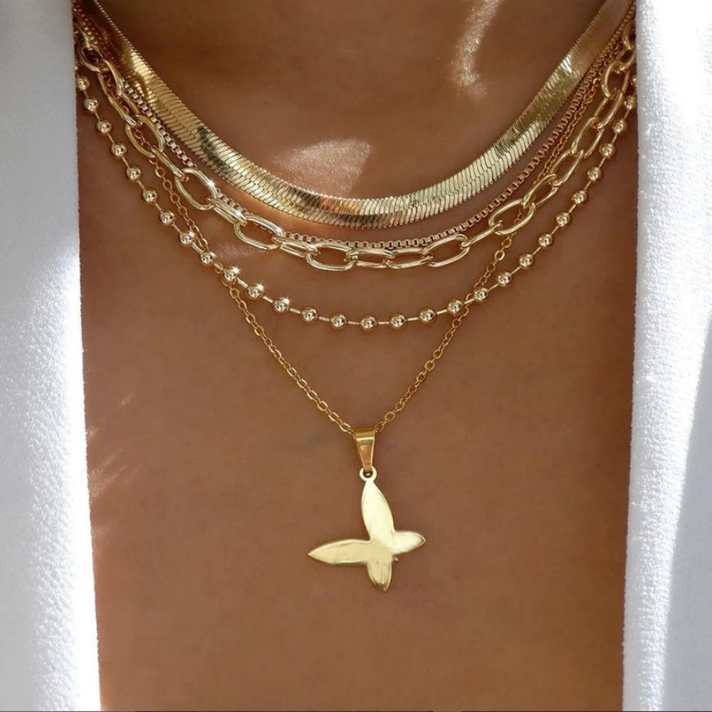 layered necklace set featuring butterfly pendant and multiple chains