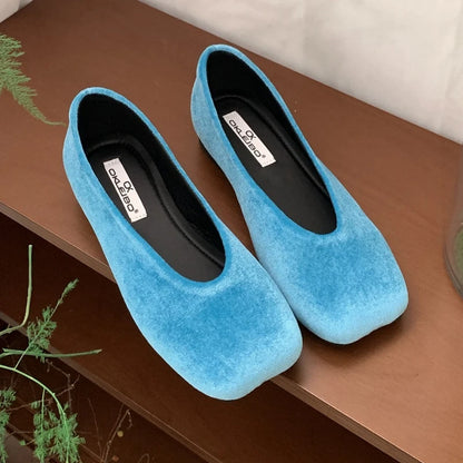 Bright blue suede slip-on flats with a square toe design for daily comfort.