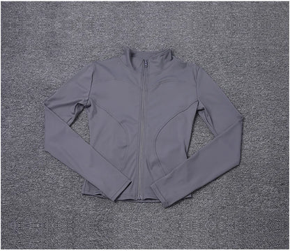 Grey polyester fitted long sleeve sport jacket with a zip front for gym training or yoga.