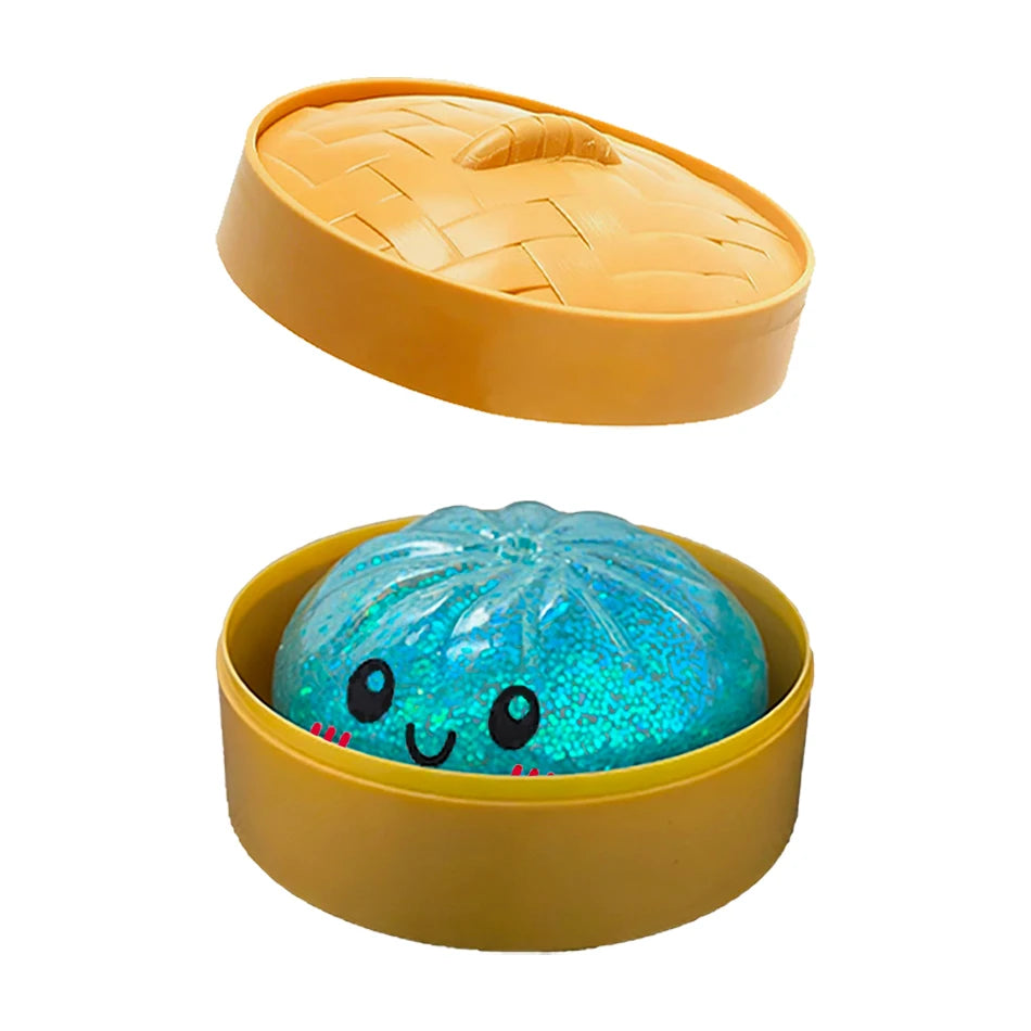 Blue glitter dumpling squishy fidget toy inside a yellow plastic bamboo steamer pot for sensory play.