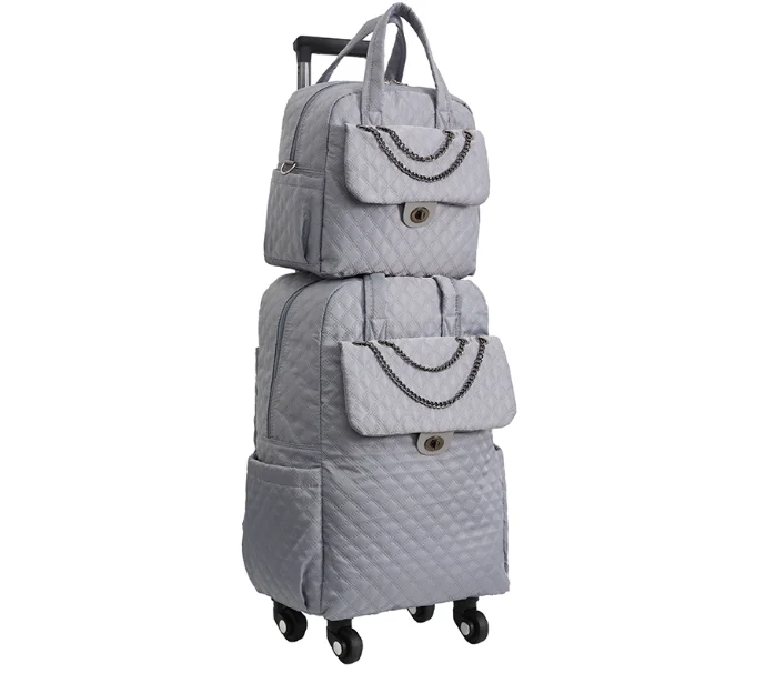 Grey quilted rolling travel bag with matching backpack, featuring chain accents and a pull handle.
