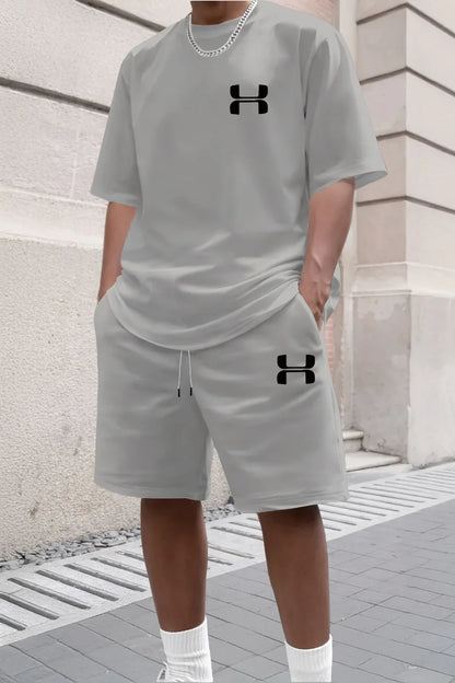 Light gray knit shorts and tee set with black logos for a relaxed fit during workouts or casual wear.