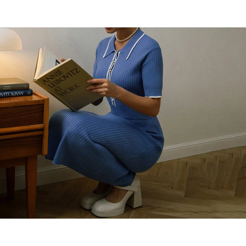 Blue ribbed knit dress with a white-trimmed polo collar, fitted for a casual reading look.