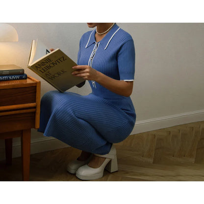 Blue ribbed knit dress with a white-trimmed polo collar, fitted for a casual reading look.